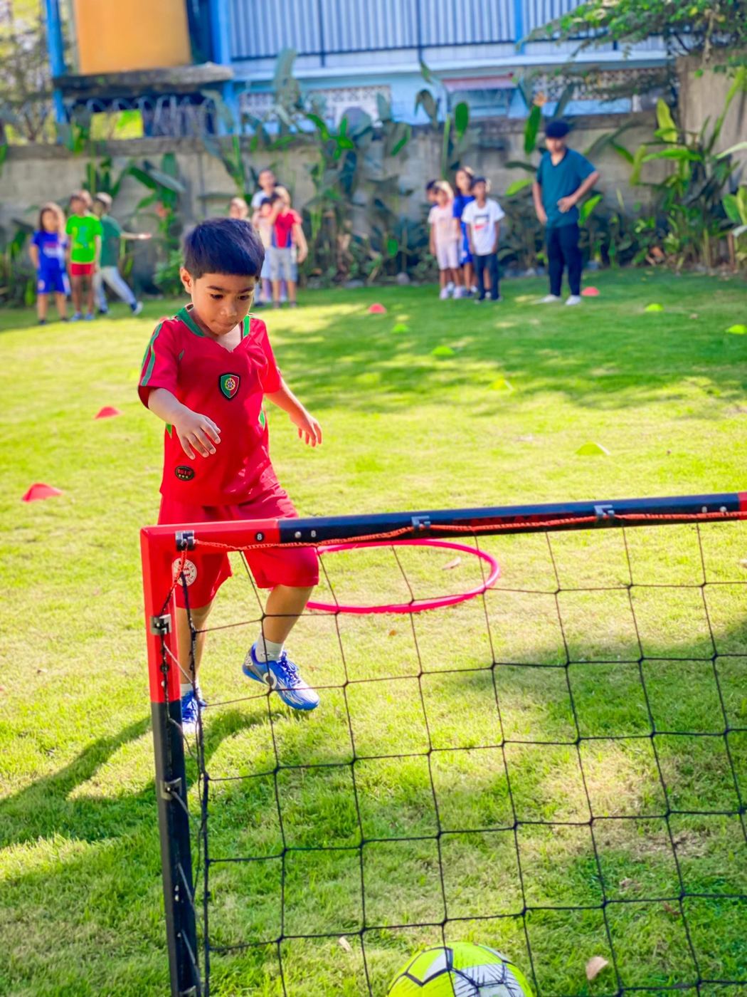 A pupil playing football on the outdoor playground